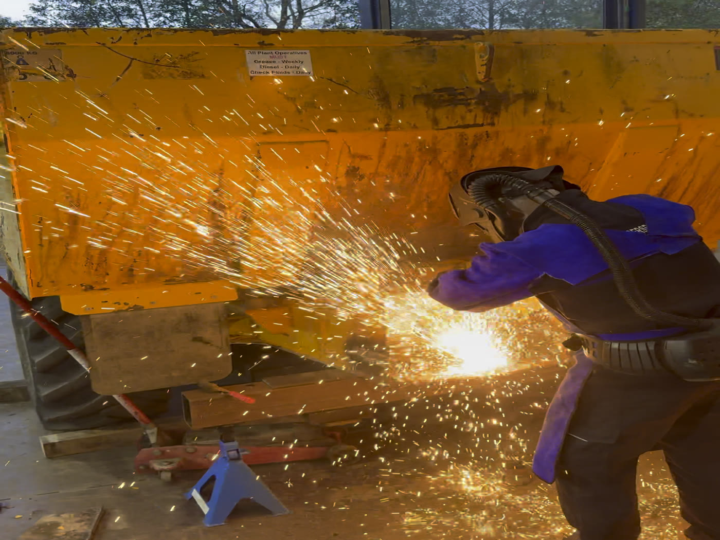 Engineers carrying out structural welding in an industrial workshop